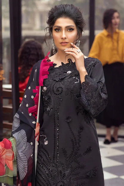 Elegant Pakistani designer dress featuring intricate embroidery and a stylish dupatta in a chic setting.