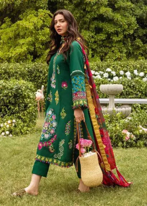 Model showcasing a green embroidered outfit from the Winter Wedding Collection in an elegant outdoor setting.