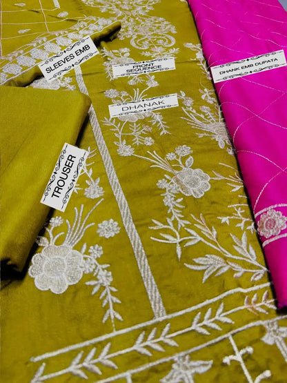 Detail of ASIM JOFA 3pc Winter Wedding Collection fabrics, showcasing yellow and pink embroidered textiles labeled for styling.