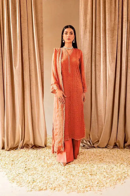 Model showcasing a beautiful orange ensemble from the Winter Wedding Collection, surrounded by floral accents.